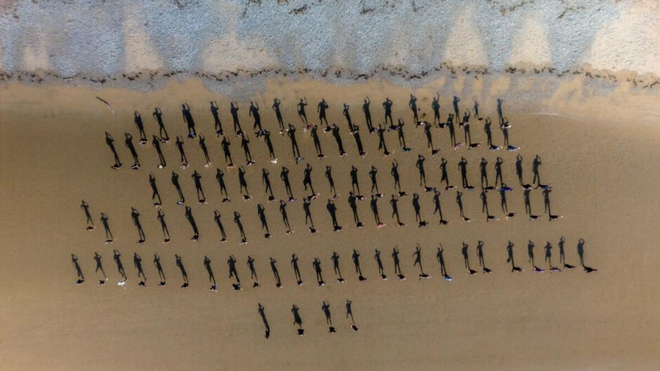 Morecambe Beach Tribute Transforms 100 People Into Striking Shadow Figures.