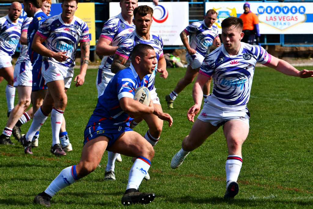 Workington Town Face Pressure in Clash with Oldham